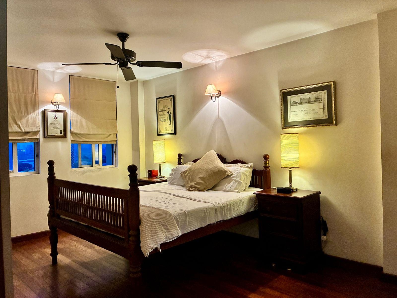 Master bedroom with teak bed and bedside lighting