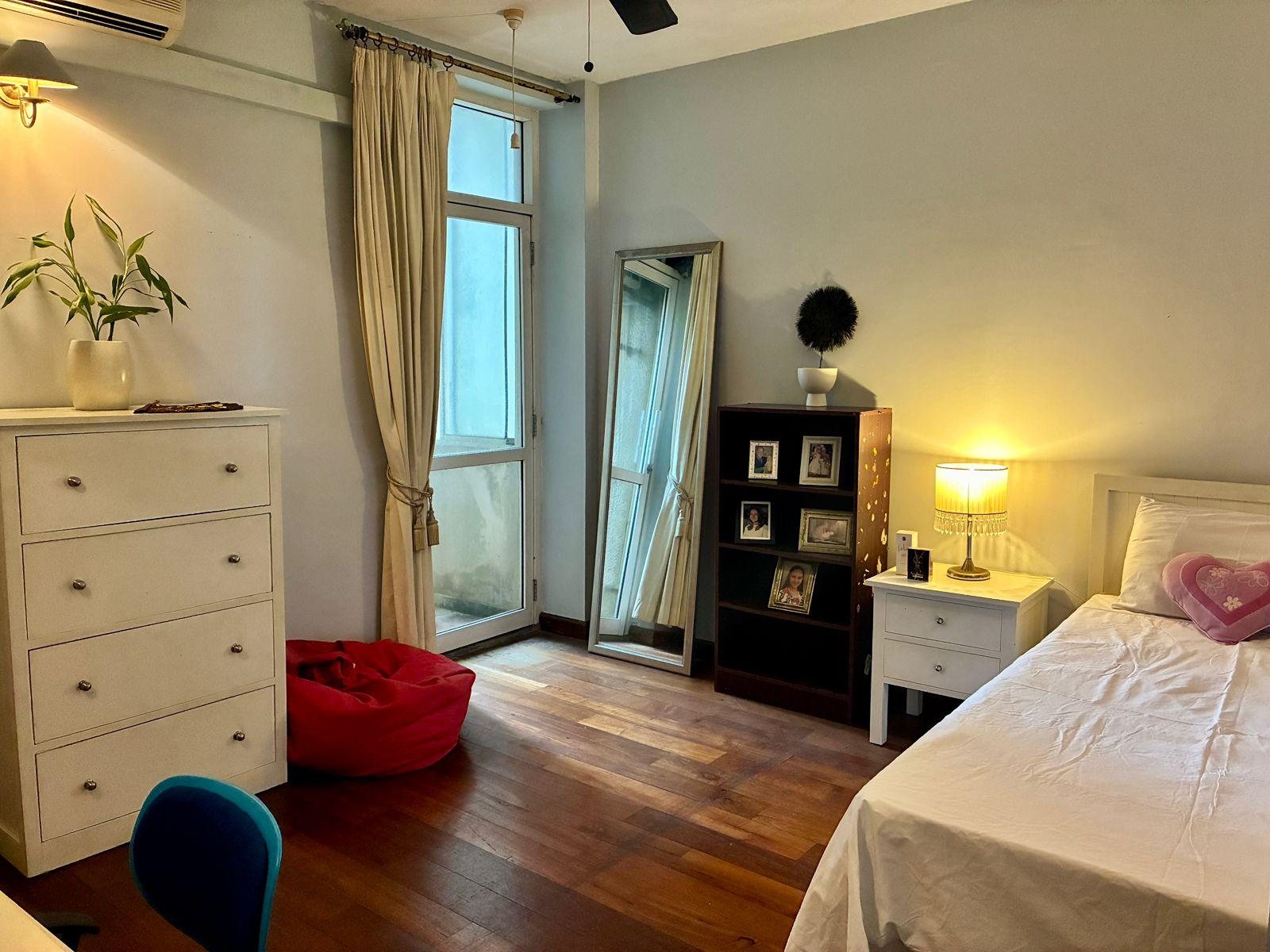 Second bedroom with built-in storage and natural light