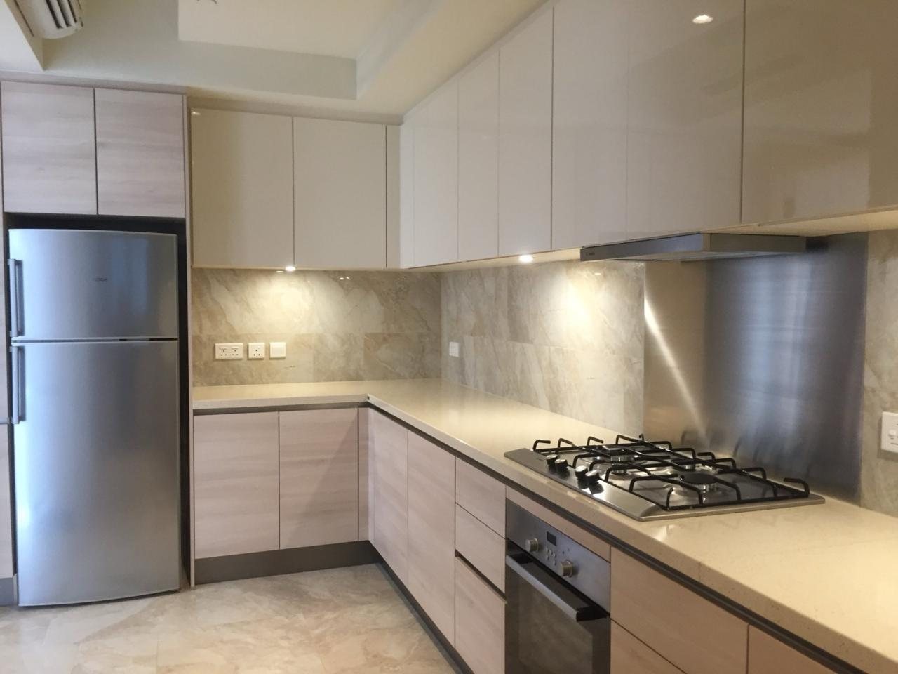Fitted kitchen with stone counters and integrated appliances
